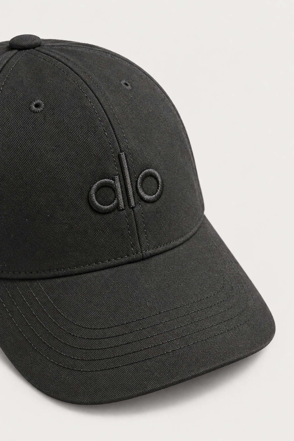 Alo Stealth Embroidered Cap — worn, close-up